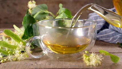 Wall Mural - Herbal linden flower tea. linden green tea in glass teapot and tea cup, with fresh linden blossom