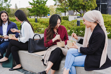 Wall Mural - Multiracial business people eating fresh poke food during lunch break outside of office