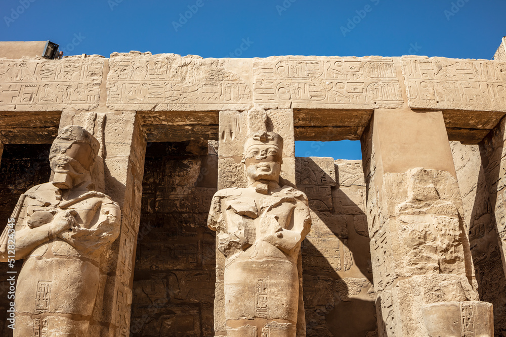Statues of ancient Egyptian pharaohs and gods. Various hieroglyphs on ...