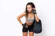 © luismolinero - Young sport Arab woman with sport bag isolated on white background listening to something by putting hand on the ear