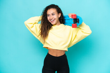 Young Arab woman isolated on blue background with a skate and looking up