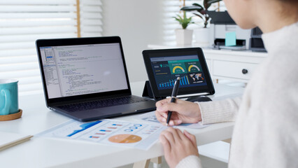 Back rear view of young asian woman, freelance data scientist work remotely at home coding programing on Big data mining, AI data engineering, IT Technician Works on Artificial Intelligence Project.