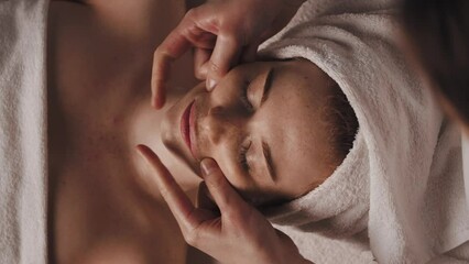 Wall Mural - beautician making facelifting massage at the beauty salon. beautiful young girl. body care. cosmetic