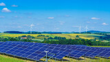 Fototapeta Góry - Wind turbines and solar panels in hilly rural area producing green energy