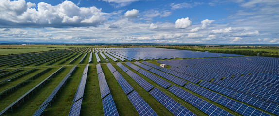 Wall Mural - Aerial view of big sustainable electric power plant with many rows of solar photovoltaic panels for producing clean electrical energy. Renewable electricity with zero emission concept