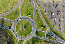 Aerial View Of Road Roundabout Intersection With Moving Heavy Traffic. Urban Circular Transportation Crossroads
