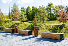 Beautiful Landscape Design Of The City Park, A Pleasant Place For Walks And Recreation Of Citizens, Wooden Benches For Sitting, A Sidewalk In The Park.