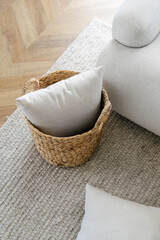 Wall Mural - Wicker basket with cushions standing on rug, near sofa