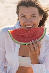 Sticker - portrait of happy young woman in white shirt holding tasty watermelon.