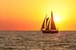 © YISM - sail boat silhouette in the sun set at the beach