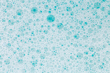 Blue Water With White Foam Bubbles.Cleanliness And Hygiene Background.foam Bubbles. Foam Water Soap Suds.Texture Foam Close-up. Blue Soap Bubbles Background. 