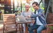 © Suriyo - Asian family father and son using computer buy life insurance online