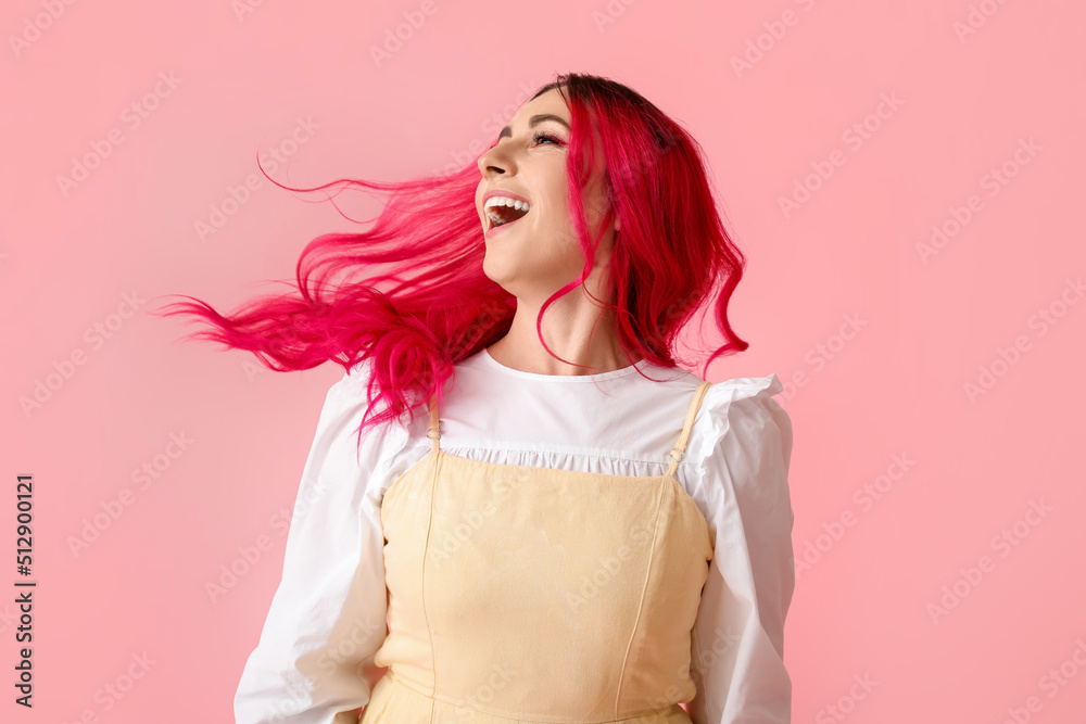Beautiful woman with bright hair on pink background