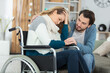 sad young woman in invalid chair and her boyfriend