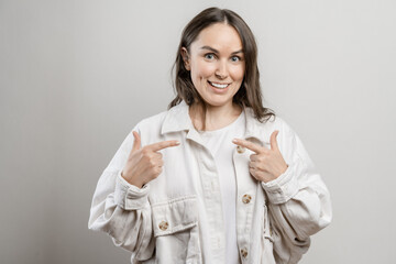 Brunette girl with long hair on a gray background