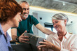 © Mediteraneo - Group of middle age friends celebrate birthday giving gifts at home