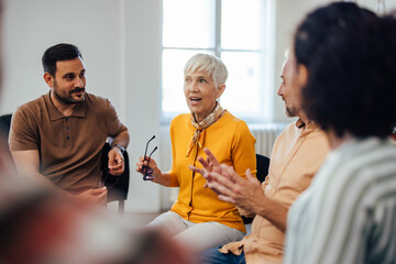 Wall Mural - The exited-looking mature woman told her life story, during the group therapy.