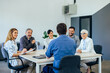 © bnenin - Group of employers having a meeting with their male boss.