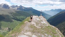 Aerial: Backpacker Alpinist Hiking To The Mountain Top Rocky Mountain Peak Dram