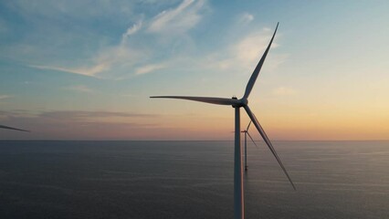 aerial view of wind turbines at sunset. working offshore wind farm. concept: power plant, climate ch