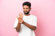 © luismolinero - Young Brazilian man isolated on pink background suffering from pain in hands