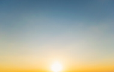 Wall Mural - Sky blue and orange light of the sun through the clouds in the sky