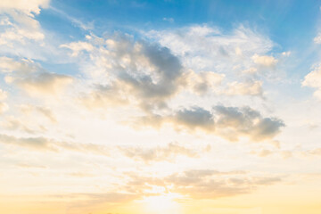 Wall Mural - Sky blue and orange light of the sun through the clouds in the sky