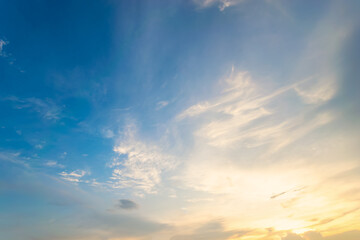 Wall Mural - Sky blue and orange light of the sun through the clouds in the sky