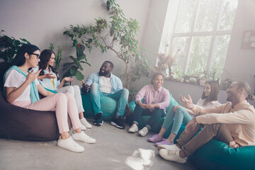 Wall Mural - Photo of good mood businesswoman businessman sitting bean bags discussing start up workplace workstation