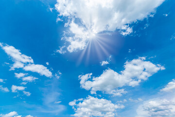 Wall Mural - Blue sky background with the sun,Blue sky with white clouds floating in the sky.