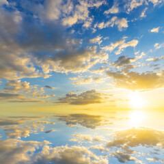 Wall Mural - Sky blue and orange light of the sun through the clouds in the sky