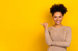 © deagreez - Photo of shiny cheerful woman wear beige sweater pointing thumb empty space isolated yellow color background