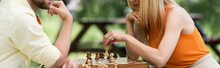 Cropped View Of Couple Playing Chess In Summer Park, Banner.