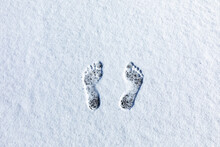 Overhead View Of Bare Footprints In Fresh Snow