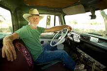 Man Wearing Cowboy Hat In Pick-up Truck