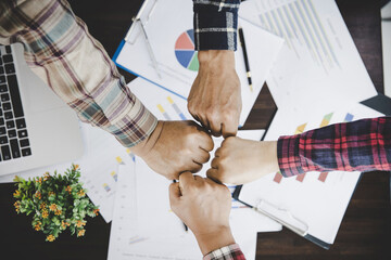 Canvas Print - young business people putting their hands together