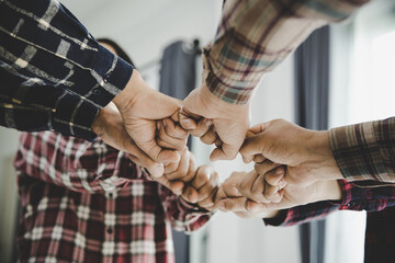 Canvas Print - young business people putting their hands together