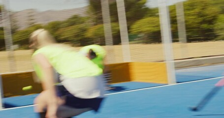 Sticker - Young hockey players running in attack and trying to score a goal during match on astroturf. Group of high school students and sports team during a game. Team of active teenagers tackling opponents