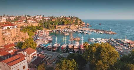 Canvas Print - Video Timelapse of cruising tourist ships and boats in the bay and port near the old town of Antalya. Turkish Riviera and tourist attraction and sea tours