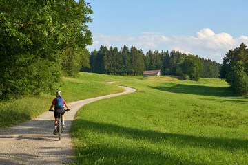 Wall Mural - pretty senior woman riding her electric mountain bike in the Allgaeu mountains above Oberstaufen , Allgau Alps, Bavaria Germany
