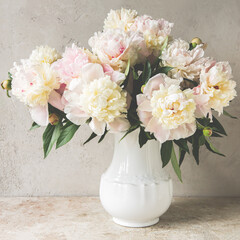Wall Mural - a jug of cream peonies on a light table