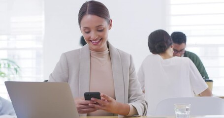 Poster - Happy young business woman using a phone to browse the internet while sitting at her desk with a laptop. A working professional checking social media at a startup agency in a modern busy office