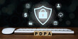 Wood block with text PDPA. Personal Data Protection Act or PDPA concept. Shield with lock icon on screen of futuristic protection from data theft.privacy.                     