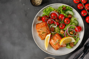 Wall Mural - Dish with Baked Salmon and green fresh vegetable salad, tomatoes cherry, onion on ceramic plate. Concept keto diet healthy food. Dinner idea.