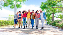 Multiethnic Group Of Friends Walking In The Street Outdoors Laughing And Having Fun. Diverse People Celebrating Life Together Enjoying Happy Summer Holidays. Lifestyle, Travel And Togetherness Concept