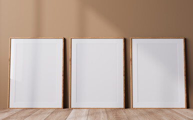 Poster frame mock up in neutral colors interior, three wooden frames in a beige background, minimal design, 3d render 