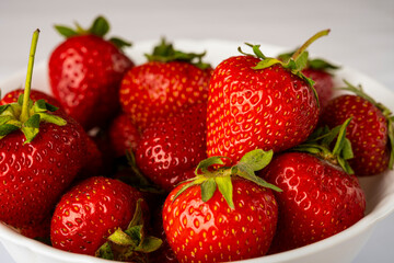 Sticker - ripe, sweet strawberries in a white plate