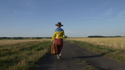 Sticker - Girl in Ukraine flag with suitcase on country road in sunset