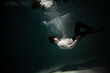 Sink. A young man is going to the bottom. A guy in a white shirt and trousers falls under the water, calmness and acceptance of fate