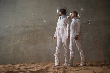 a man and a woman in white futuristic spacesuits explore the planet, astronauts in an empty colony o